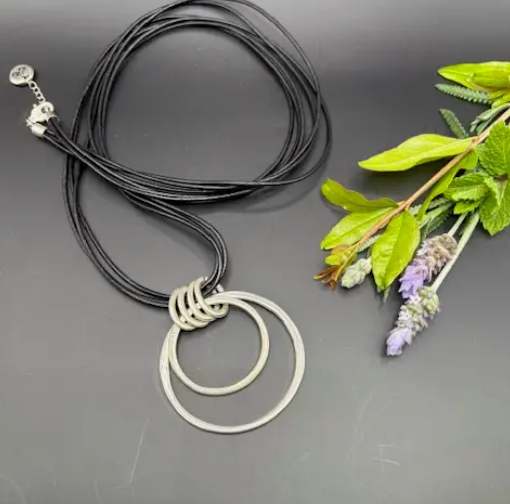 Double Circle Pendant On Black Cord Necklace